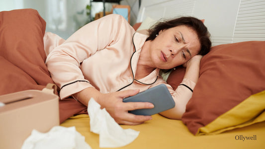 A woman lying in bed, struggling with illness.